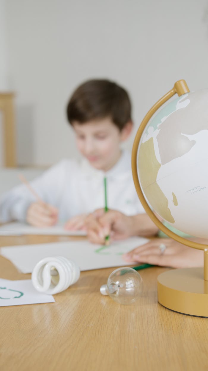 A child studies with a globe, emphasizing education and sustainability themes.